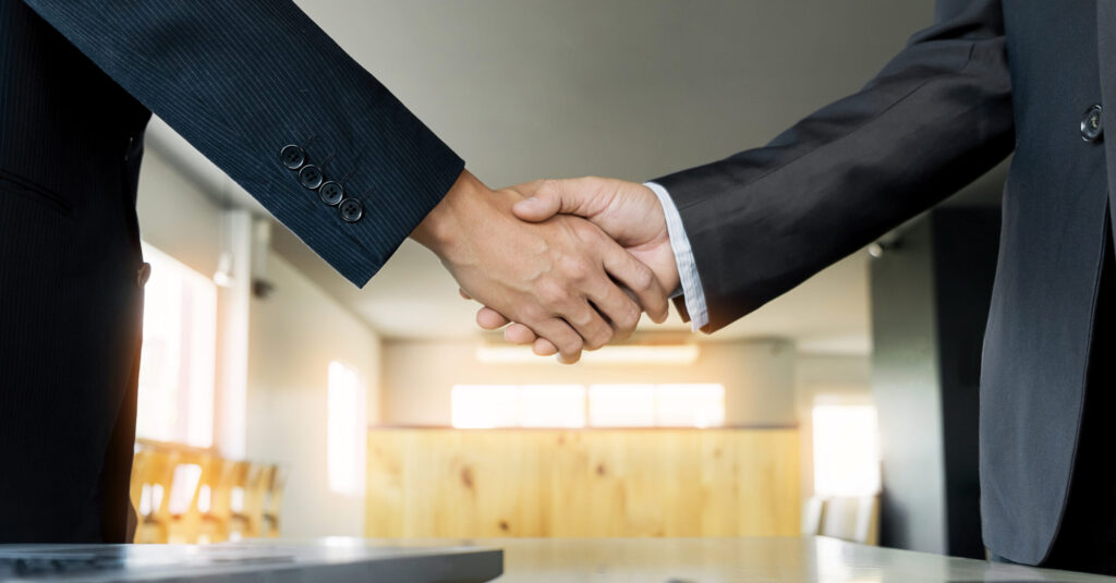 Two Confident Business Man Shaking Hands During Meeting In The Office Success Dealing Greeting And Partner Concept Scaled E1630342794757 1024x535